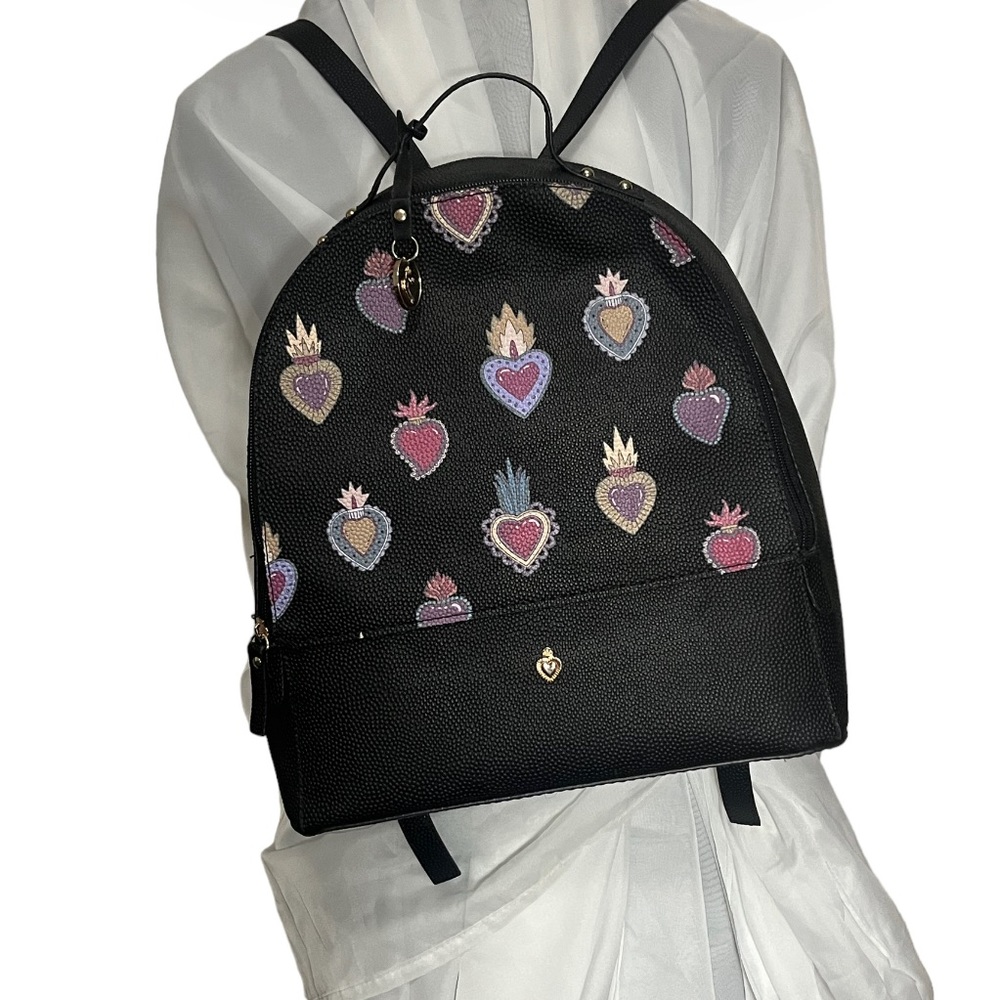 W Capsule Backpack with adjustable straps. Heart print on black material.